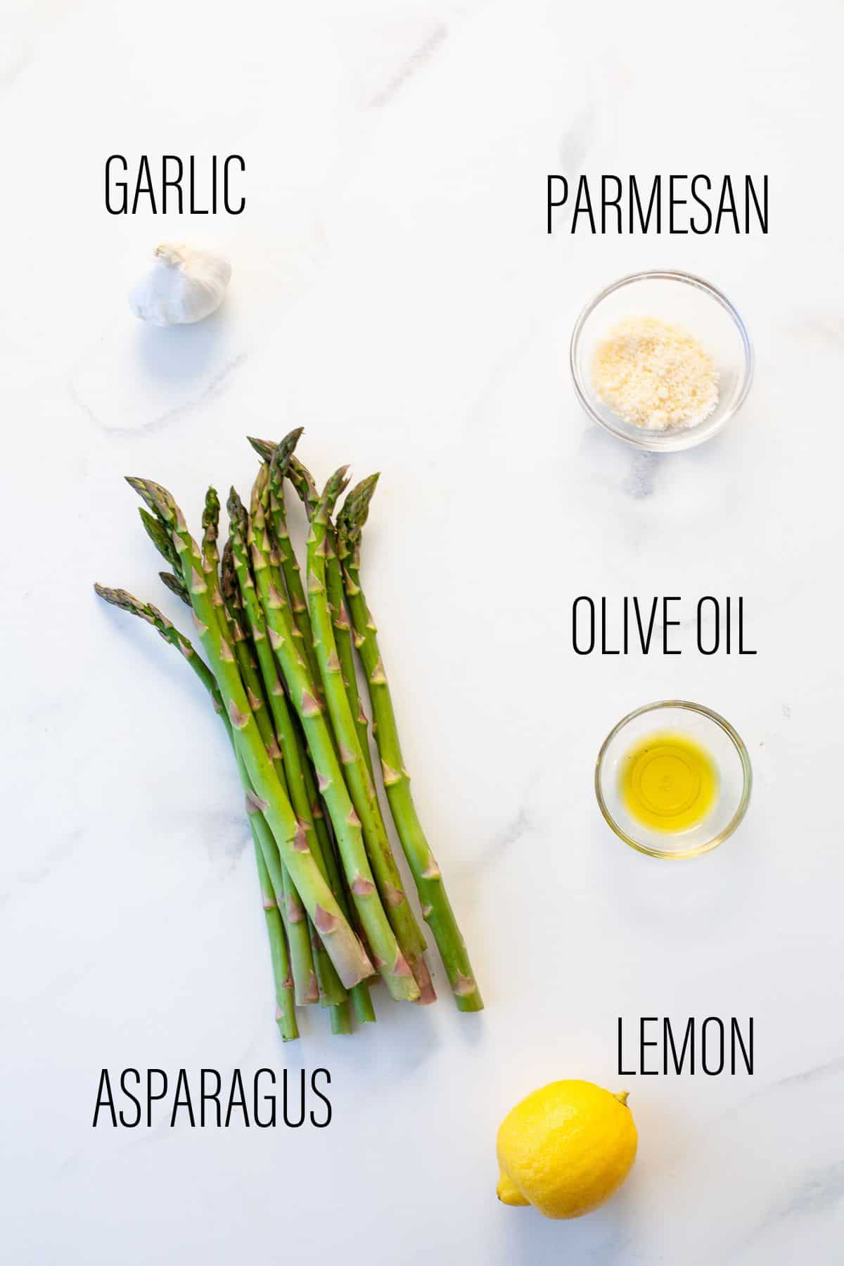 ingredients to make instant pot asparagus on white marbled background
