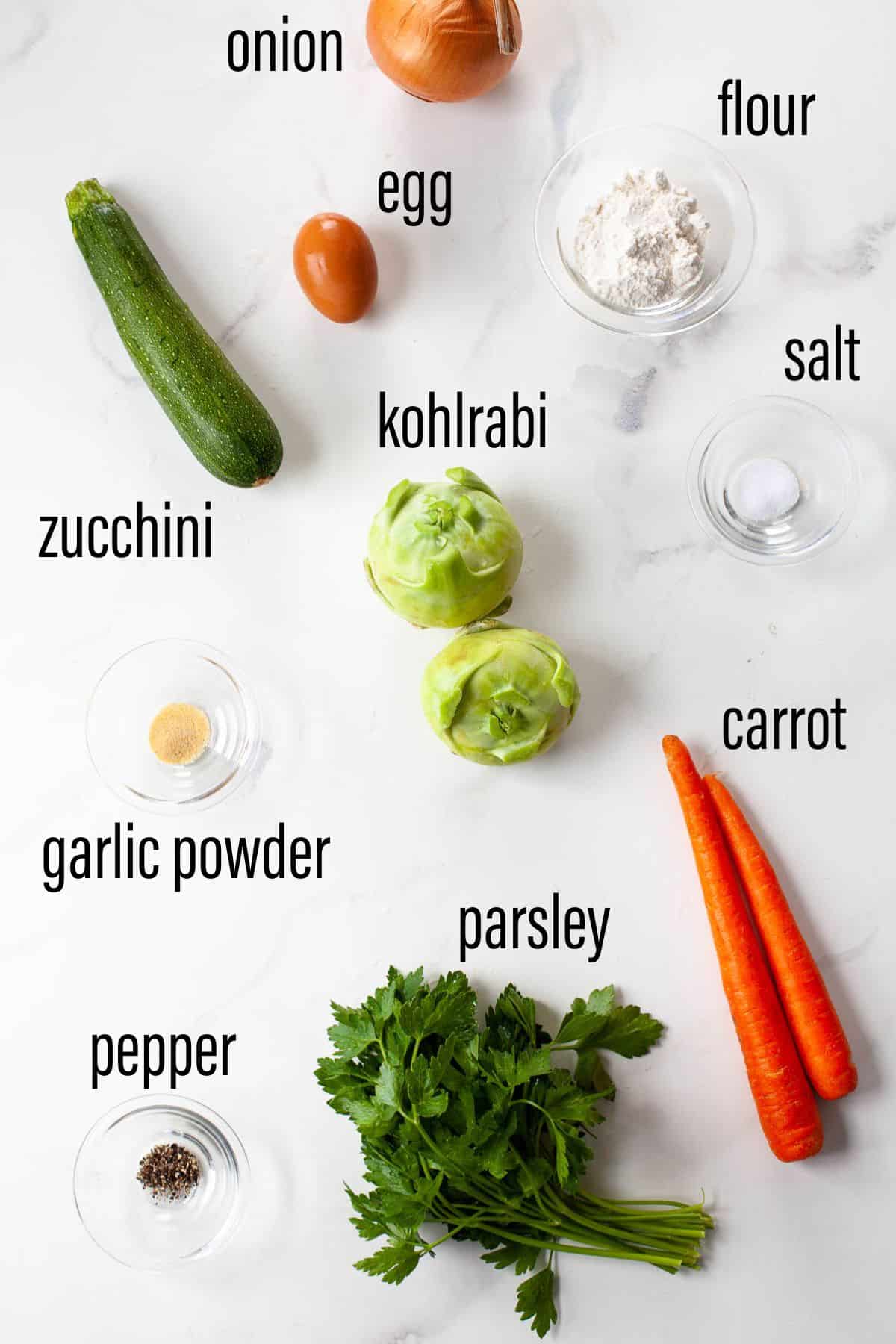 graphic of ingredients for kohlrabi fritters on marble surface with black text overlay 